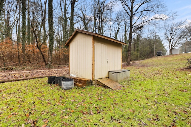 view of outbuilding with a lawn