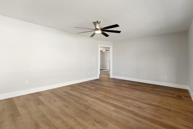 empty room featuring hardwood / wood-style flooring and ceiling fan