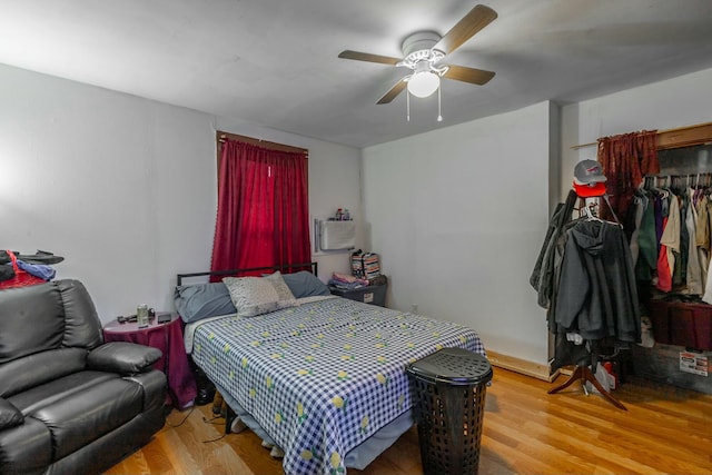 bedroom with light hardwood / wood-style floors and ceiling fan