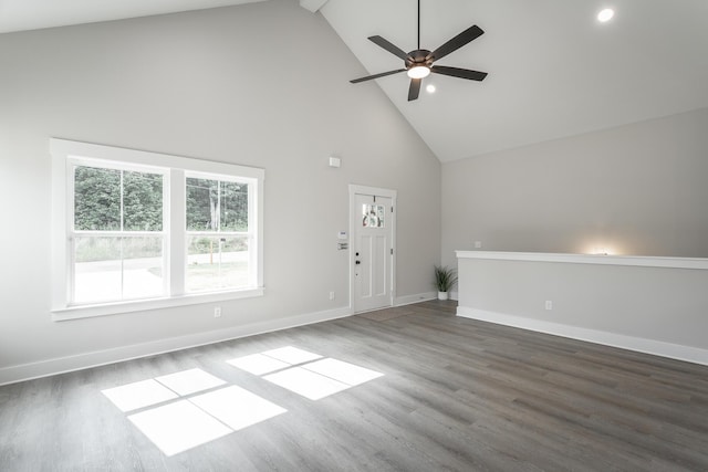 unfurnished living room with ceiling fan, dark wood-type flooring, and high vaulted ceiling