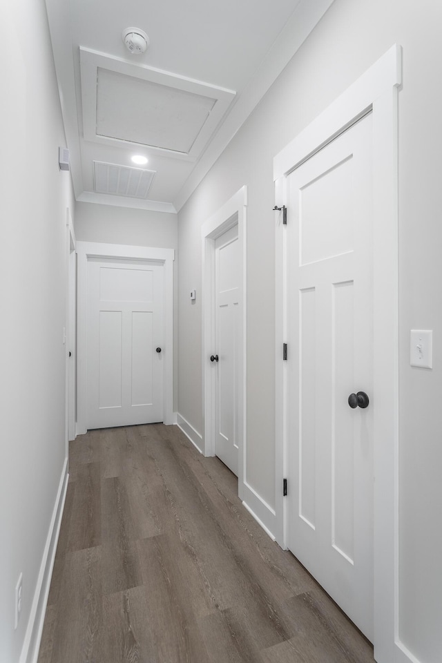 hall featuring hardwood / wood-style flooring and ornamental molding