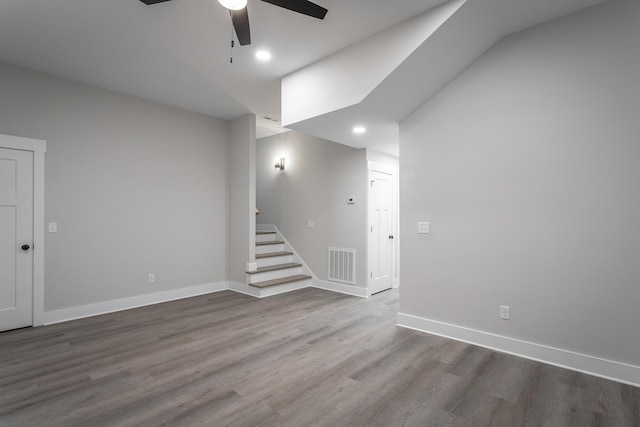 basement featuring hardwood / wood-style flooring and ceiling fan