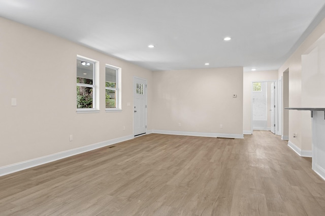 unfurnished living room featuring light wood-type flooring