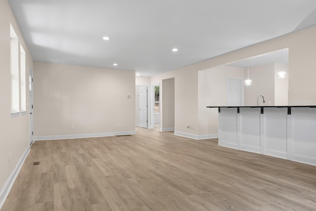 unfurnished living room featuring light hardwood / wood-style flooring