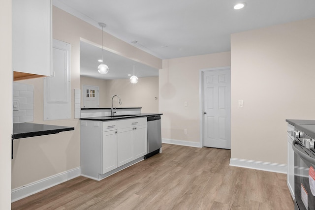 kitchen featuring appliances with stainless steel finishes, pendant lighting, sink, white cabinets, and light wood-type flooring