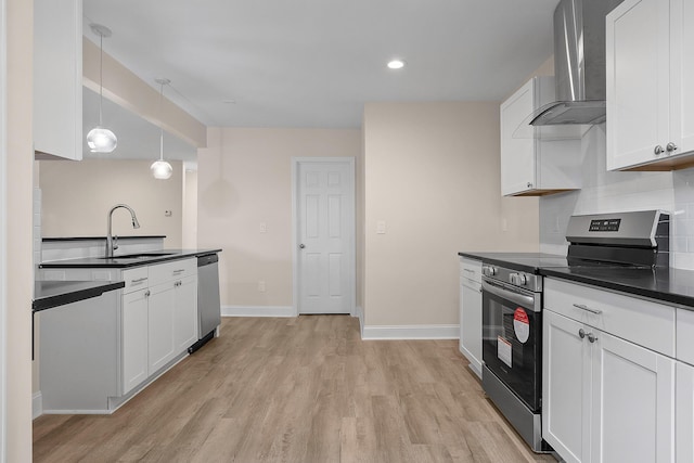 kitchen with wall chimney exhaust hood, sink, white cabinetry, pendant lighting, and stainless steel appliances