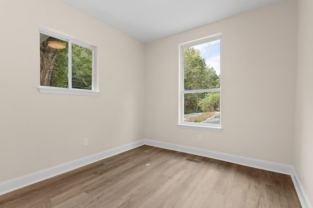 unfurnished room with light wood-type flooring