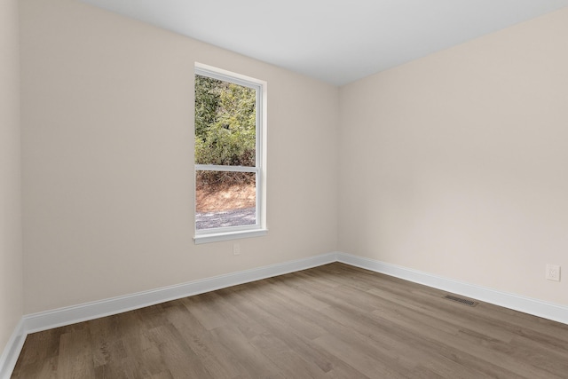 spare room featuring light hardwood / wood-style floors