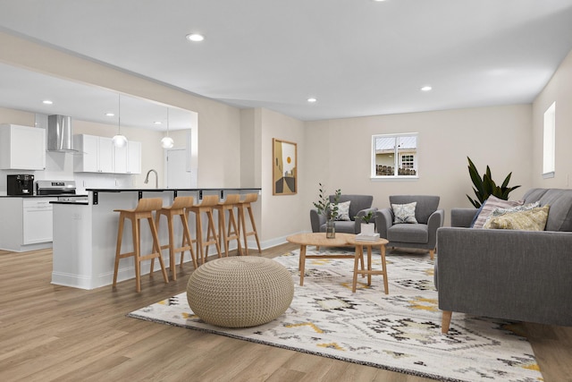 living room with sink and light hardwood / wood-style floors