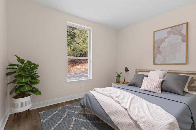 bedroom with dark wood-type flooring