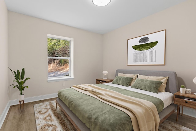 bedroom with hardwood / wood-style floors