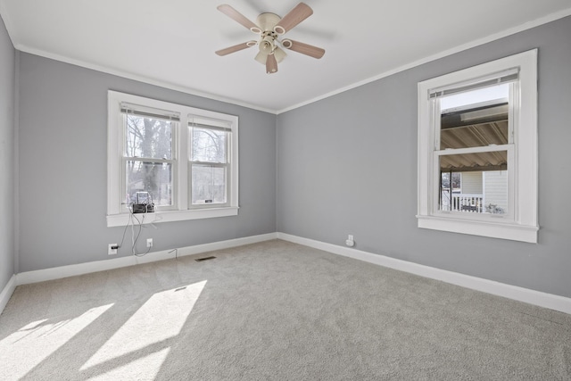 carpeted empty room featuring ornamental molding and ceiling fan