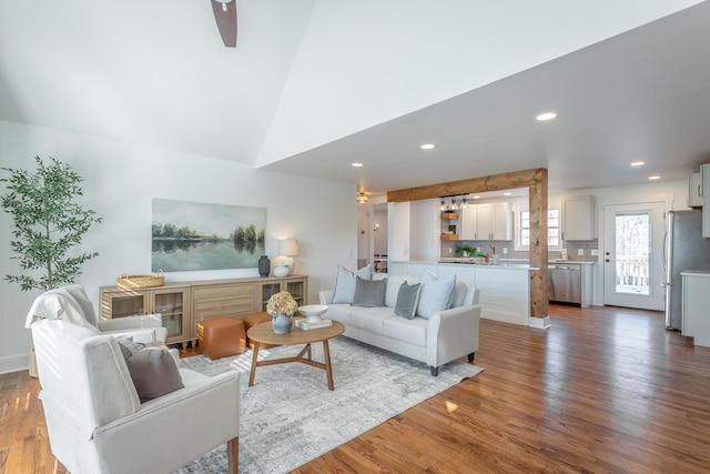 living room with vaulted ceiling and hardwood / wood-style floors