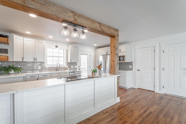 kitchen with sink, white cabinets, backsplash, stainless steel refrigerator with ice dispenser, and dark wood-type flooring