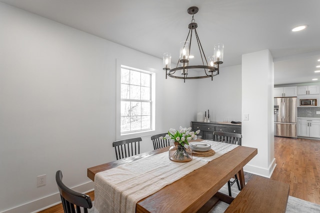 dining area with an inviting chandelier and wood-type flooring