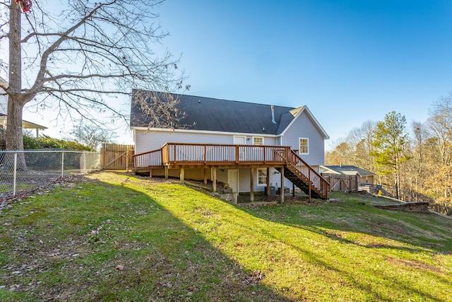 rear view of property featuring a deck and a lawn