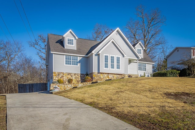 cape cod-style house with a front lawn