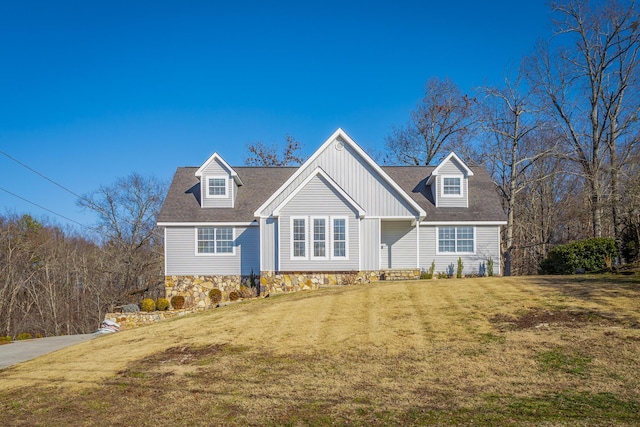 cape cod-style house with a front lawn