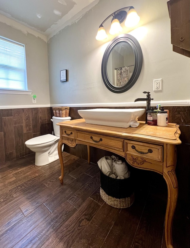 bathroom with ornamental molding, vanity, toilet, and hardwood / wood-style floors