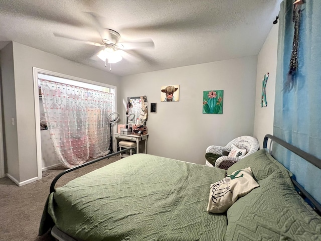 bedroom featuring ceiling fan, carpet, and a textured ceiling