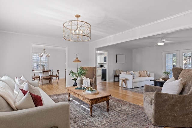 living room featuring hardwood / wood-style flooring, ornamental molding, french doors, and a wealth of natural light