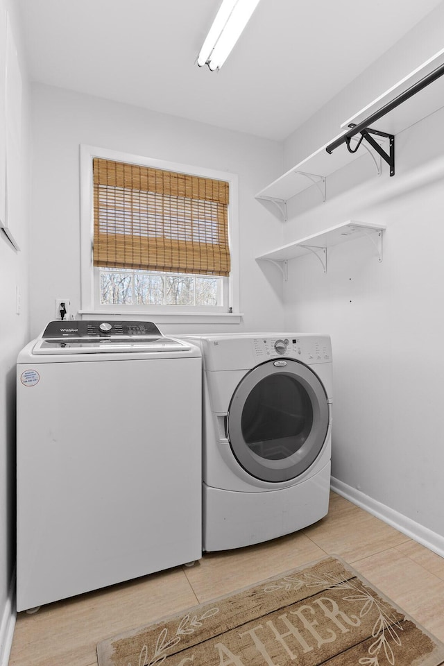 laundry area featuring light hardwood / wood-style floors and washing machine and dryer