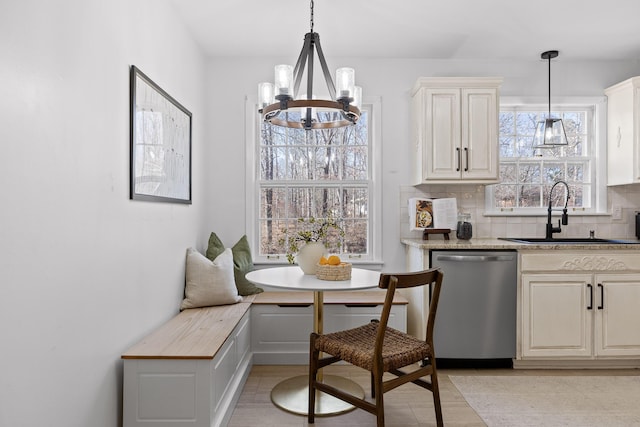 dining area with breakfast area, sink, and a notable chandelier