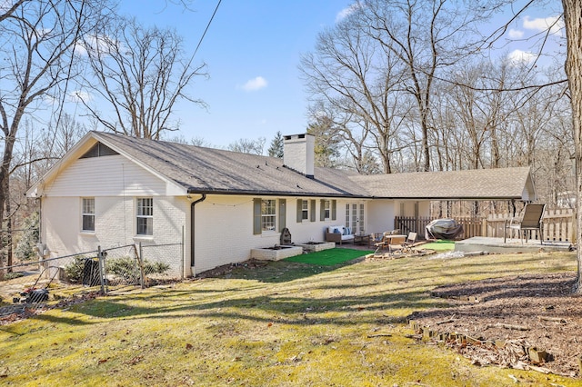 back of house with a patio area and a lawn