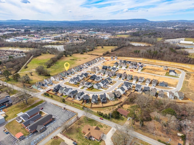 birds eye view of property with a mountain view and a residential view