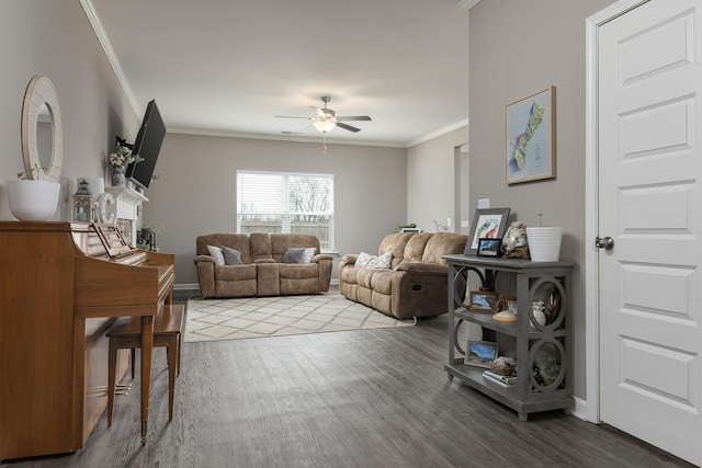 living room with baseboards, wood finished floors, a ceiling fan, and crown molding