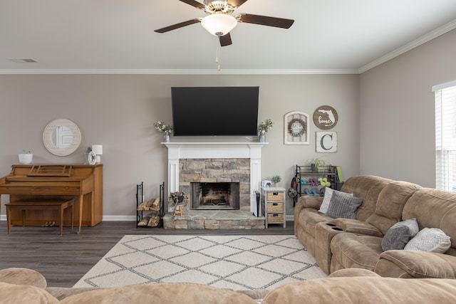 living room featuring baseboards, ceiling fan, wood finished floors, crown molding, and a fireplace