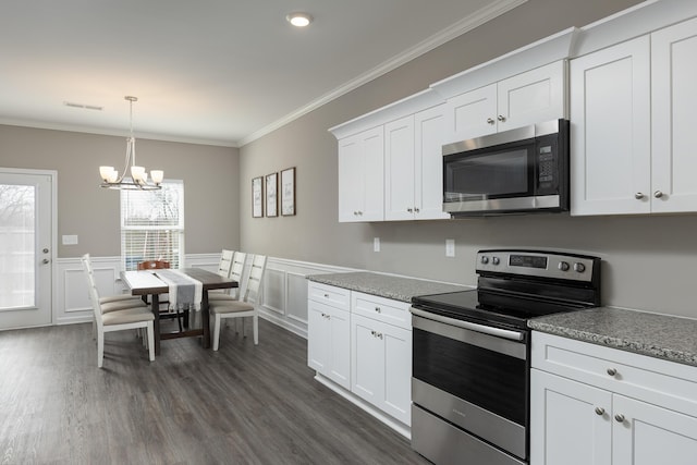 kitchen with visible vents, dark wood-style floors, stainless steel appliances, crown molding, and white cabinetry