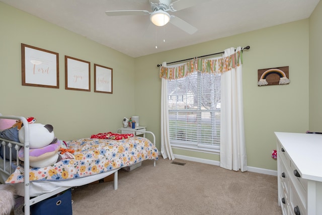 bedroom with visible vents, baseboards, light colored carpet, and a ceiling fan