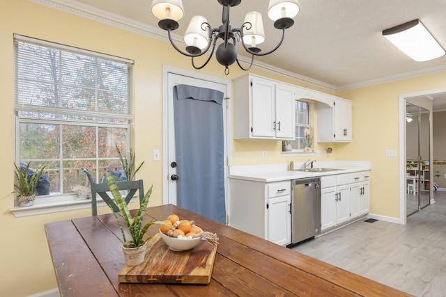 kitchen with a chandelier, ornamental molding, white cabinets, and stainless steel dishwasher