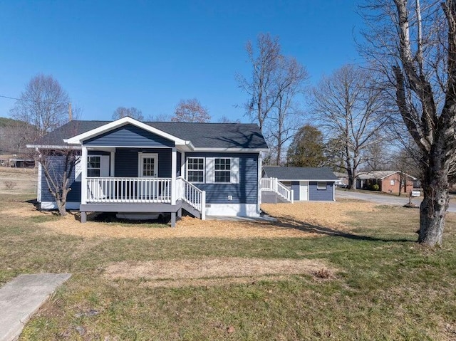 view of front of house with a deck and a front yard