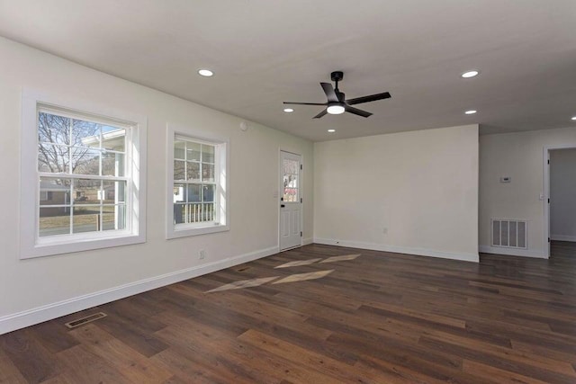 interior space featuring dark wood-type flooring and ceiling fan