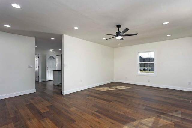 empty room with dark hardwood / wood-style floors and ceiling fan