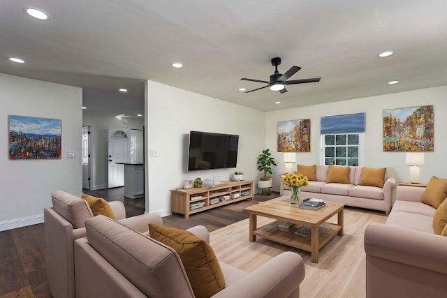 living room featuring wood-type flooring and ceiling fan