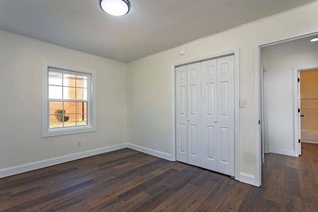 unfurnished bedroom featuring dark hardwood / wood-style floors and a closet