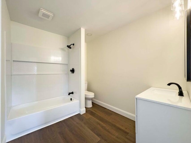 full bathroom with hardwood / wood-style flooring, vanity, toilet, and shower / bathing tub combination