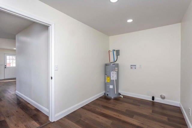 clothes washing area with washer hookup, dark wood-type flooring, and electric water heater