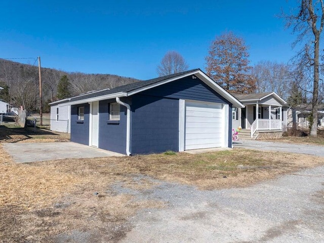 exterior space with a garage and covered porch