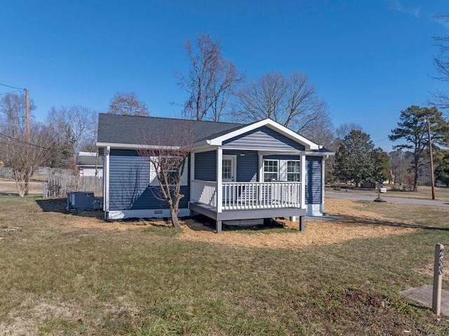 view of front of house with a wooden deck, central AC, and a front lawn