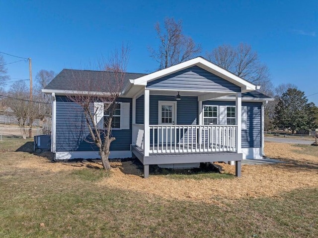 view of front of house with a wooden deck and a front lawn