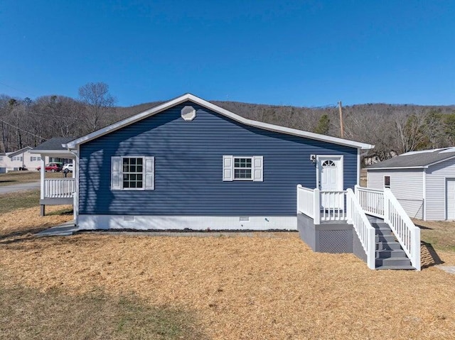 rear view of house featuring a lawn