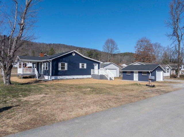 ranch-style home with a porch, a garage, and a front yard