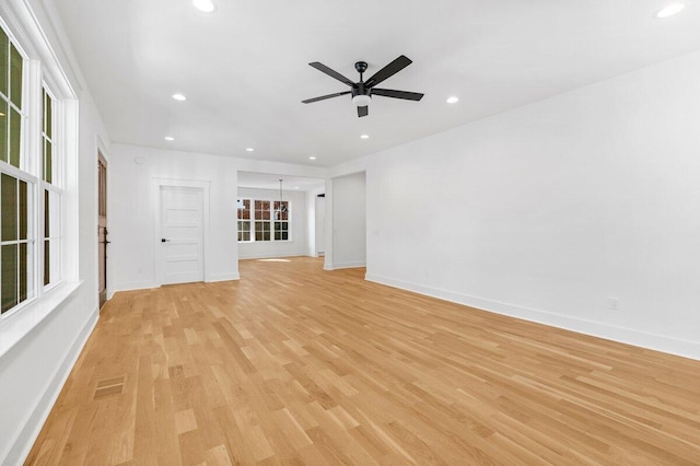 unfurnished living room with light hardwood / wood-style flooring and ceiling fan