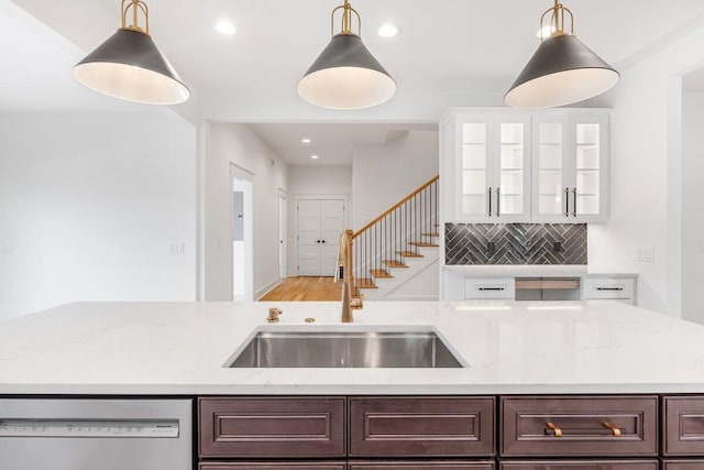 kitchen with white dishwasher, sink, white cabinetry, and dark brown cabinets