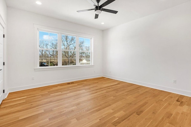 unfurnished room with ceiling fan and light wood-type flooring