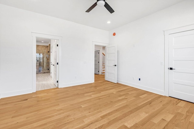 unfurnished bedroom featuring ceiling fan, ensuite bathroom, and light hardwood / wood-style floors